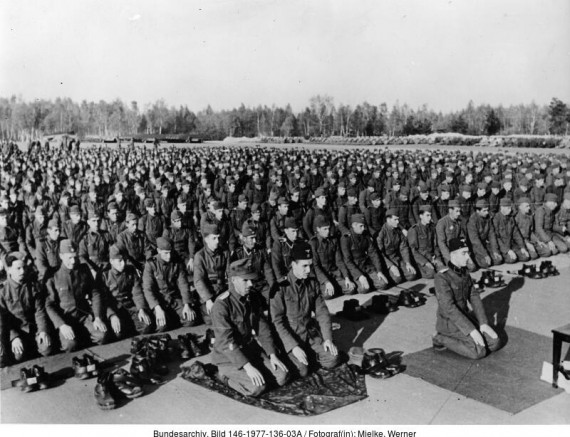 schwarz-weiß Foto mit Soldaten, die betend am Boden knien